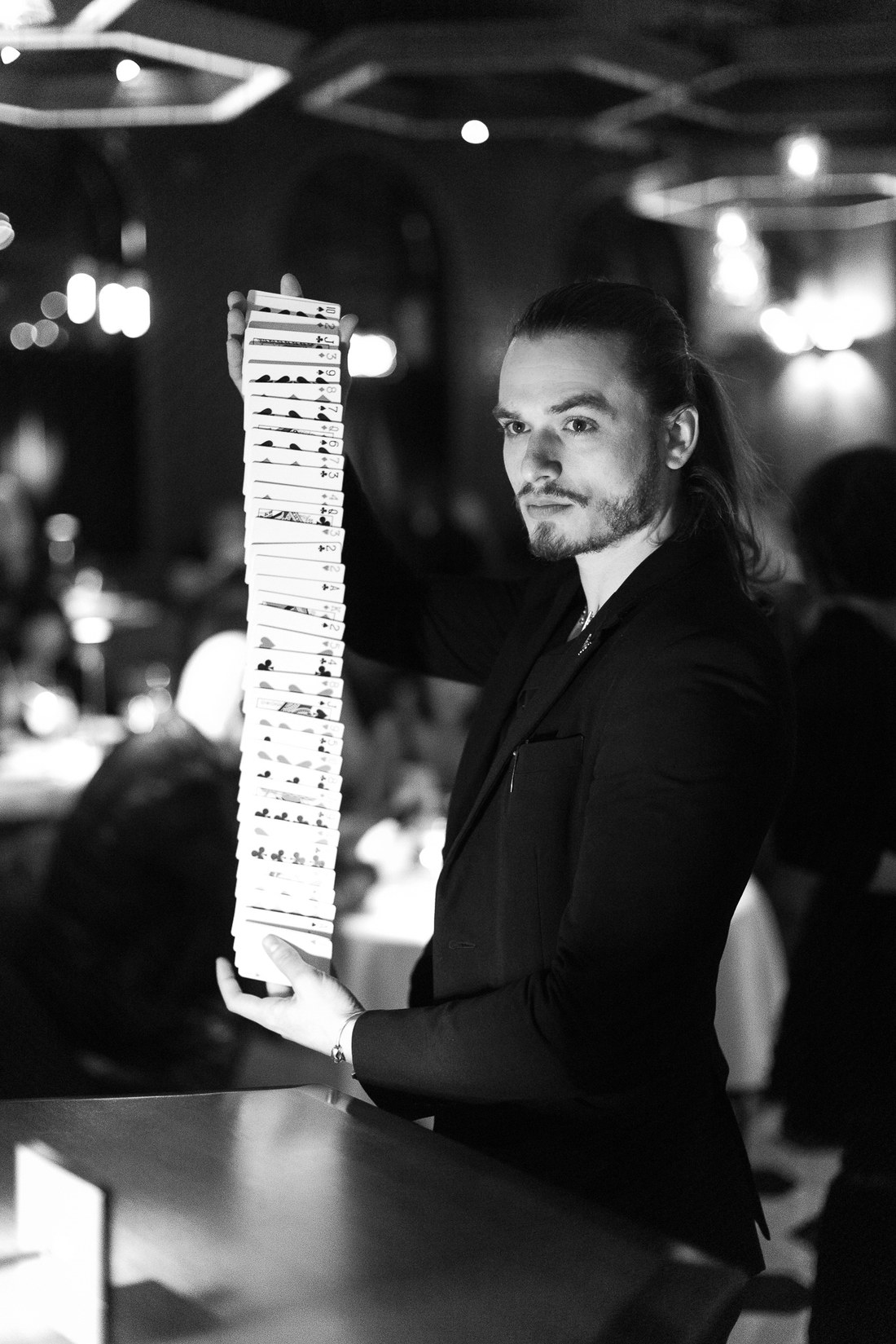 Magicman holding a cascade of cards